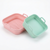Reusable silicone air fryer liner 2-pack pink and green on white background
